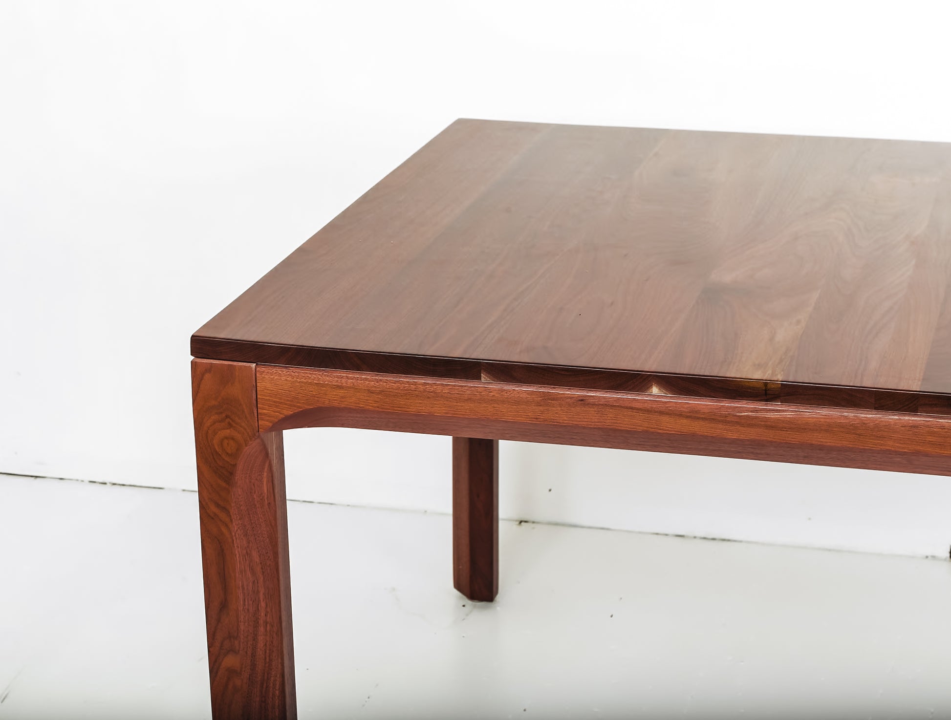 Handmade walnut dining table with a sleek matte finish for modern homes
