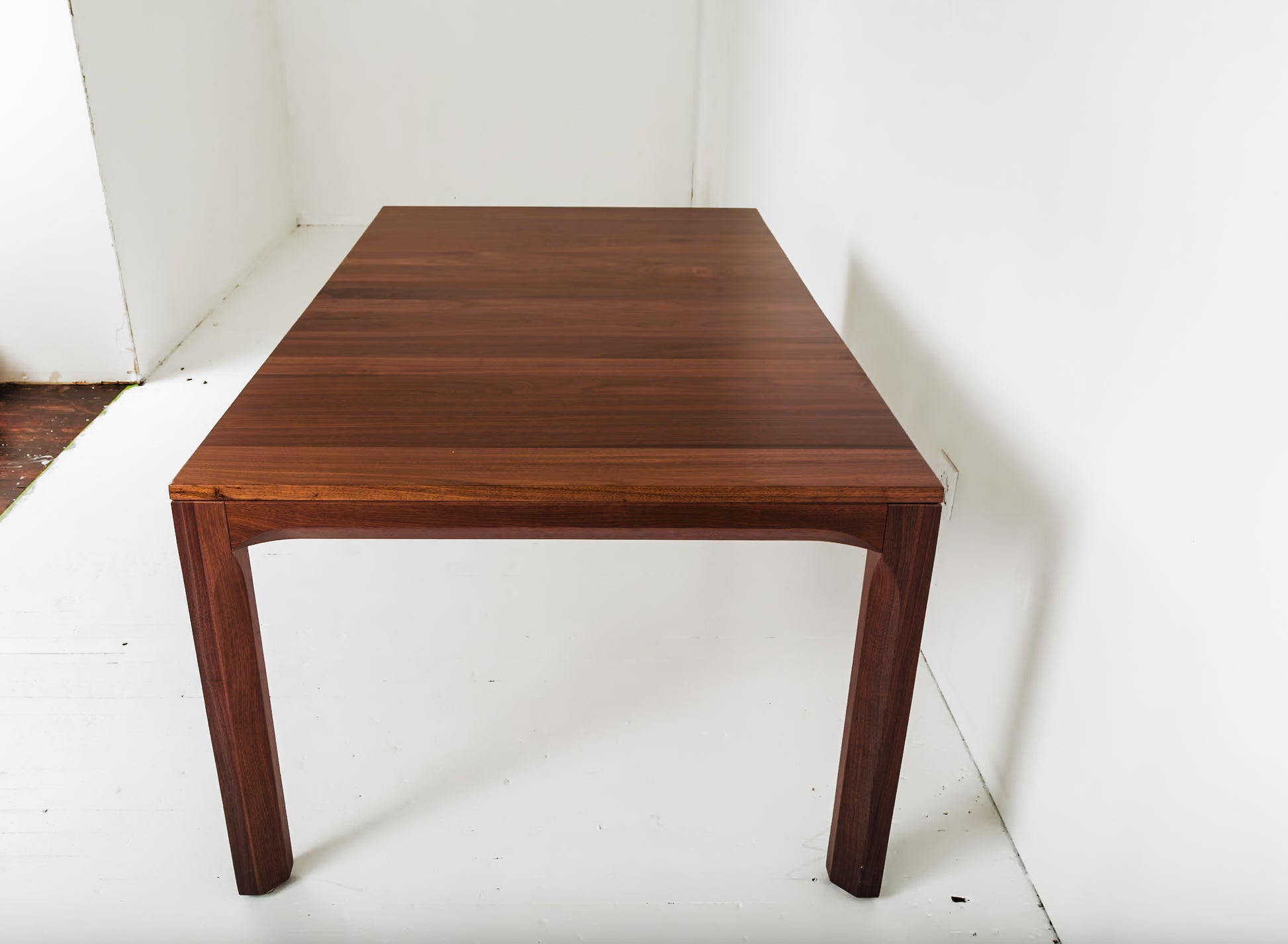 Compagno walnut dining table with a bench, ideal for minimalist decor

