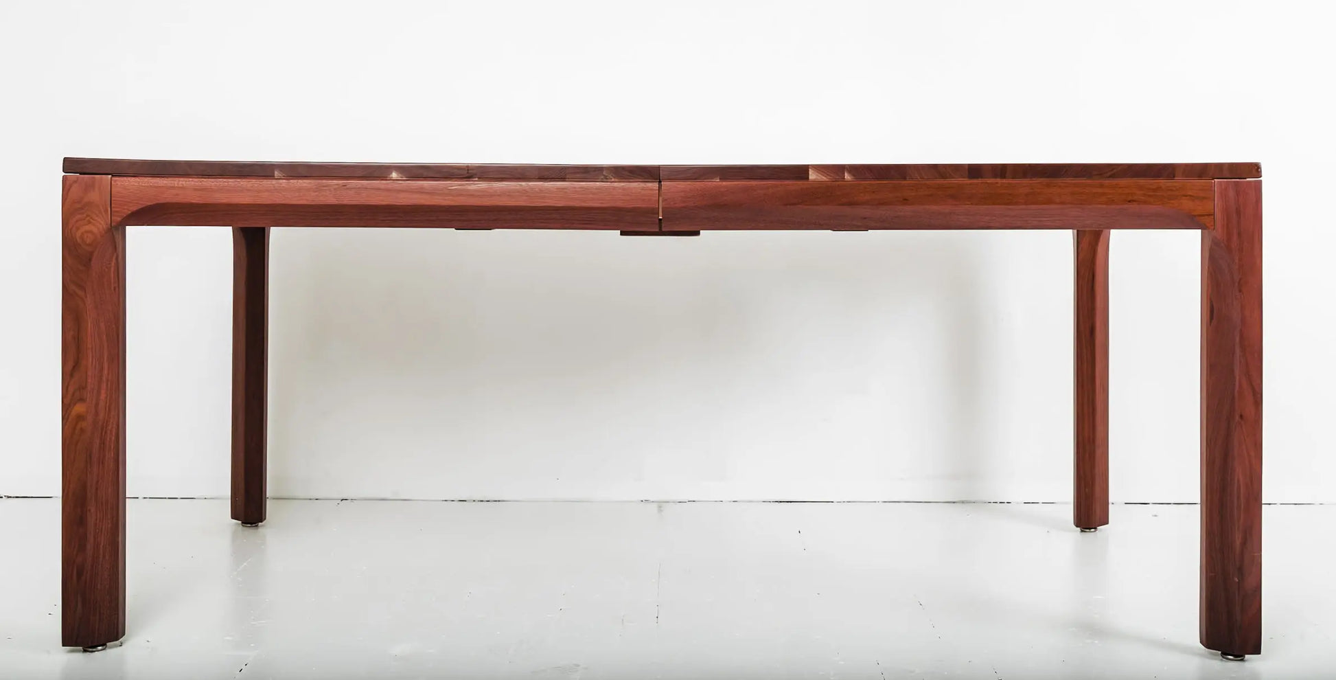 High-quality walnut extendable dining table with sleek, minimalist lines
