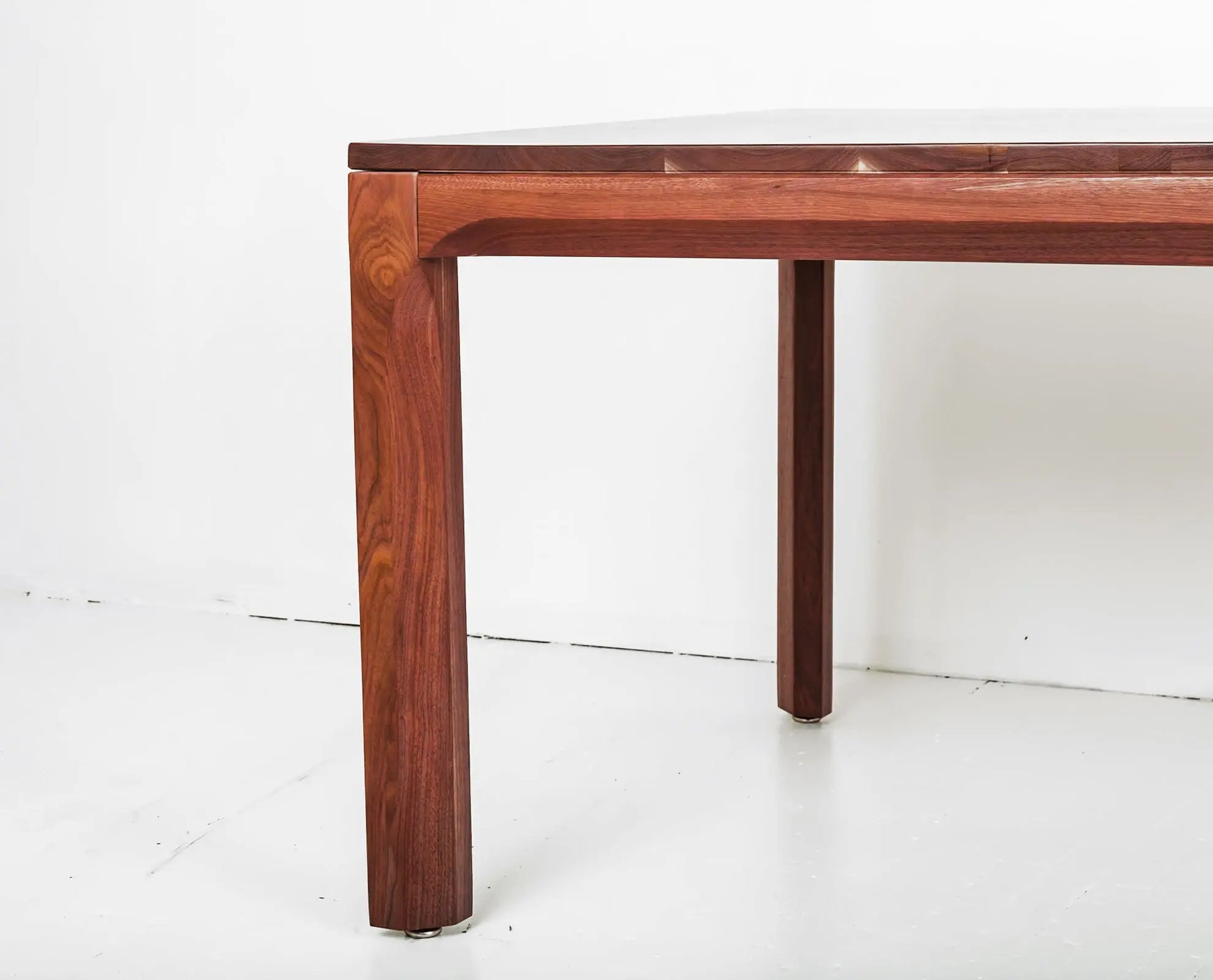 Mid-century modern dining table in walnut with extendable leaf options

