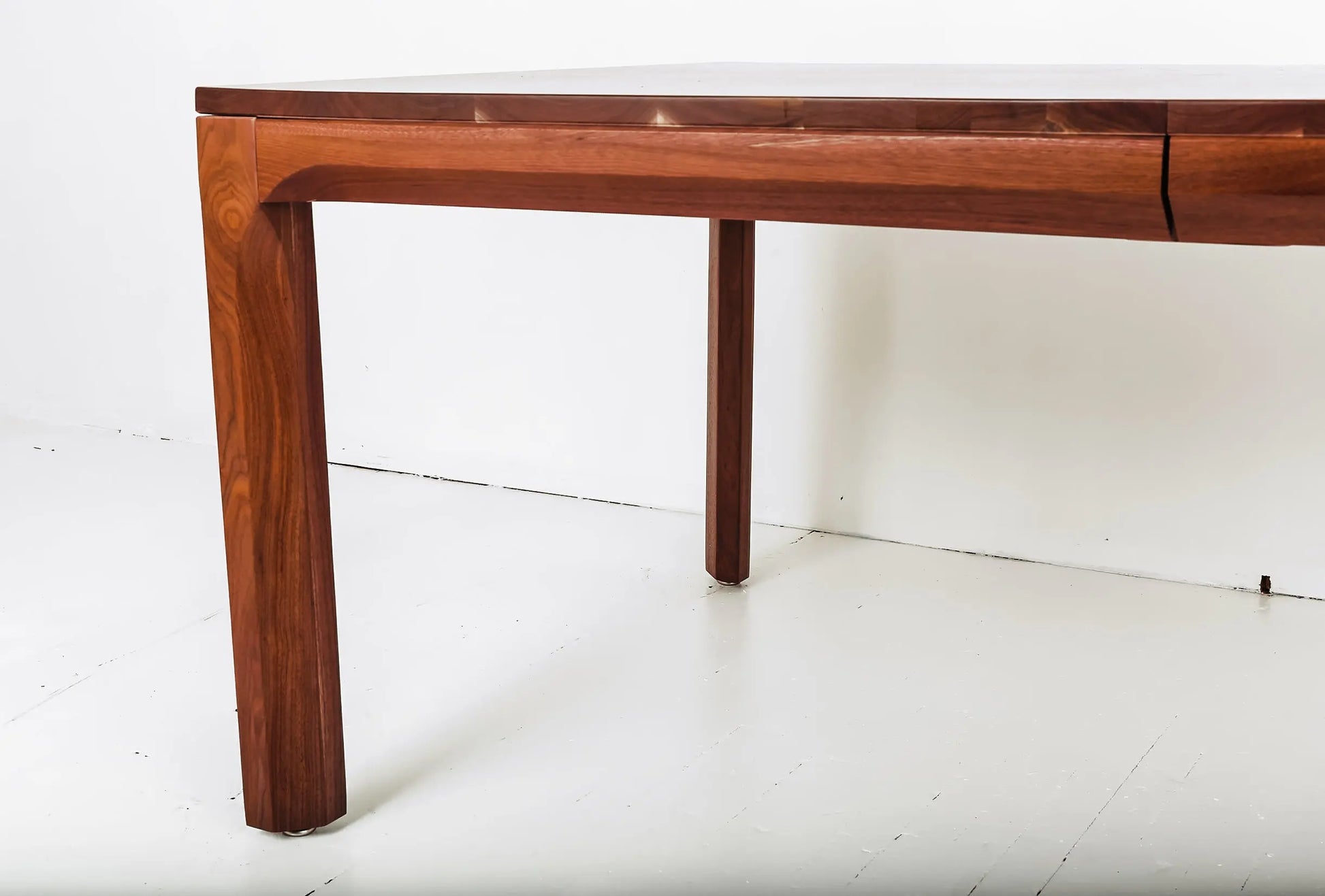 Eco-conscious dining table in walnut with a contemporary bench seat
