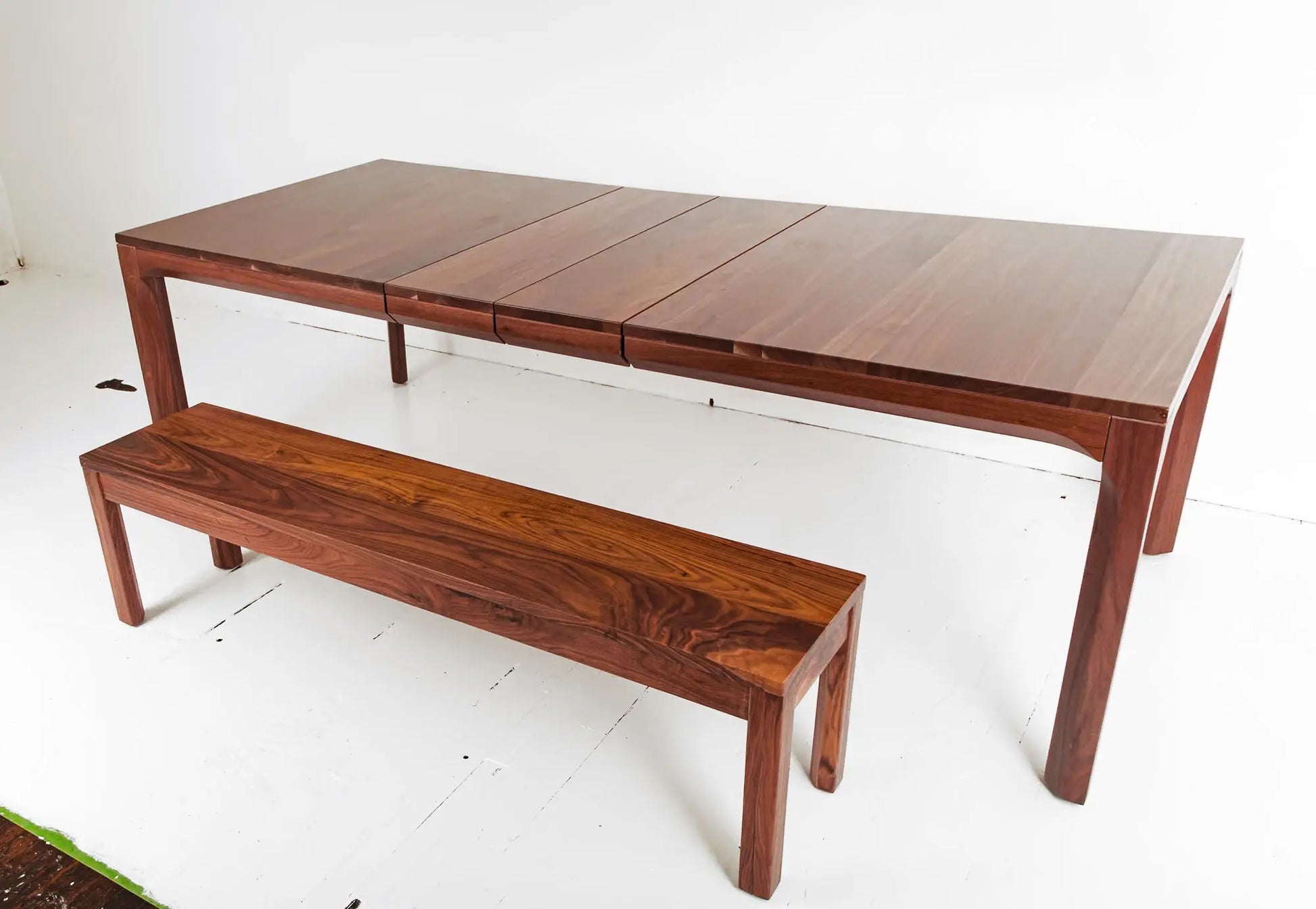 Eco-friendly walnut dining table with extendable leaves and minimalist style
