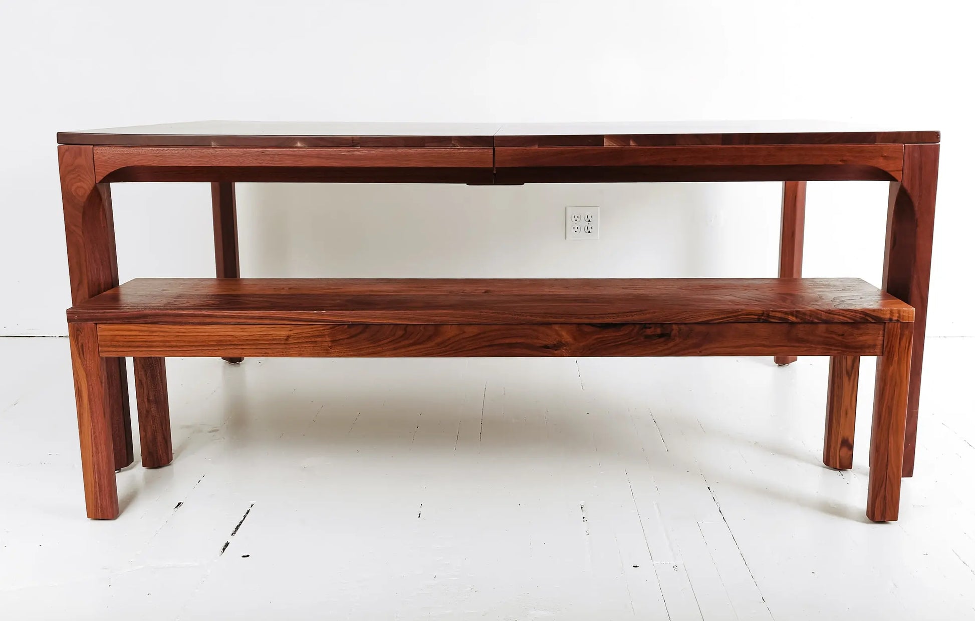 Custom walnut dining table with clean, modern lines and bold accent chairs
