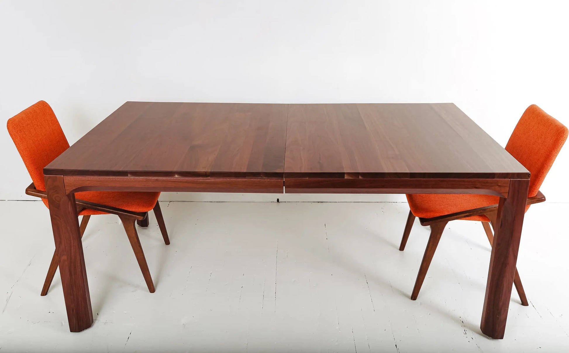 Sleek walnut dining table with bench and chairs, perfect for Japandi style

