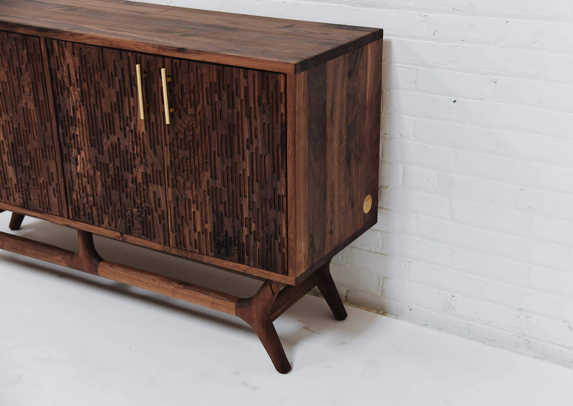 Close-up of the Elmore's intricate walnut grain, highlighting the quality craftsmanship typical of modern wooden sideboards.