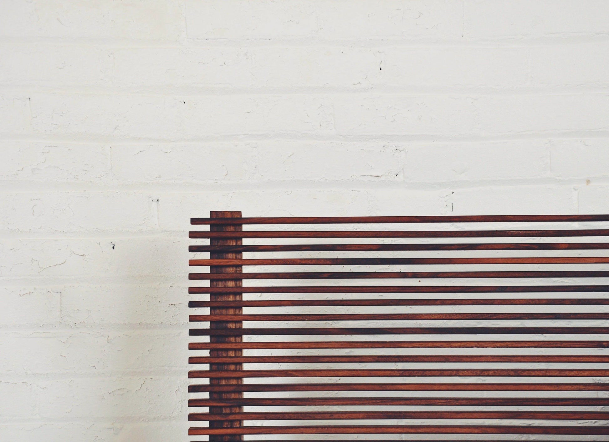 Baxter bed frame showcasing its 10-degree tilted louvered headboard in a room setting