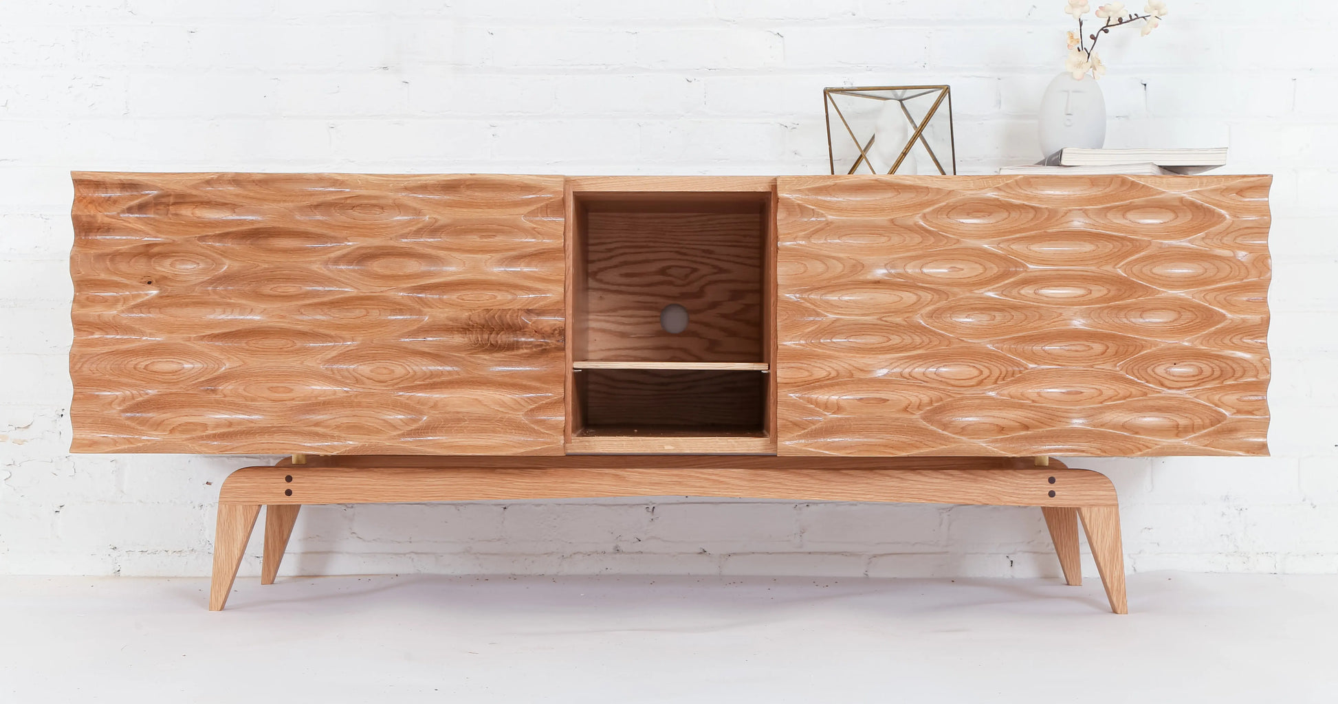 Modern credenza with midcentury legs and 3d textured door in oak