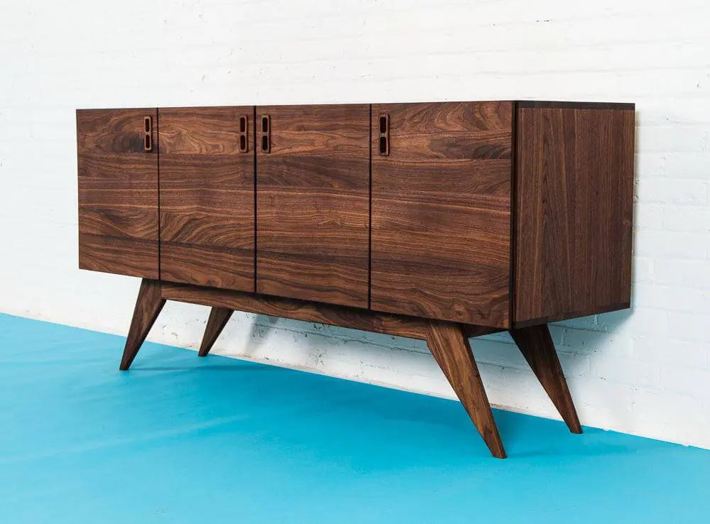 Scandinavian Modern walnut Credenza on Blue floor with White Wall.