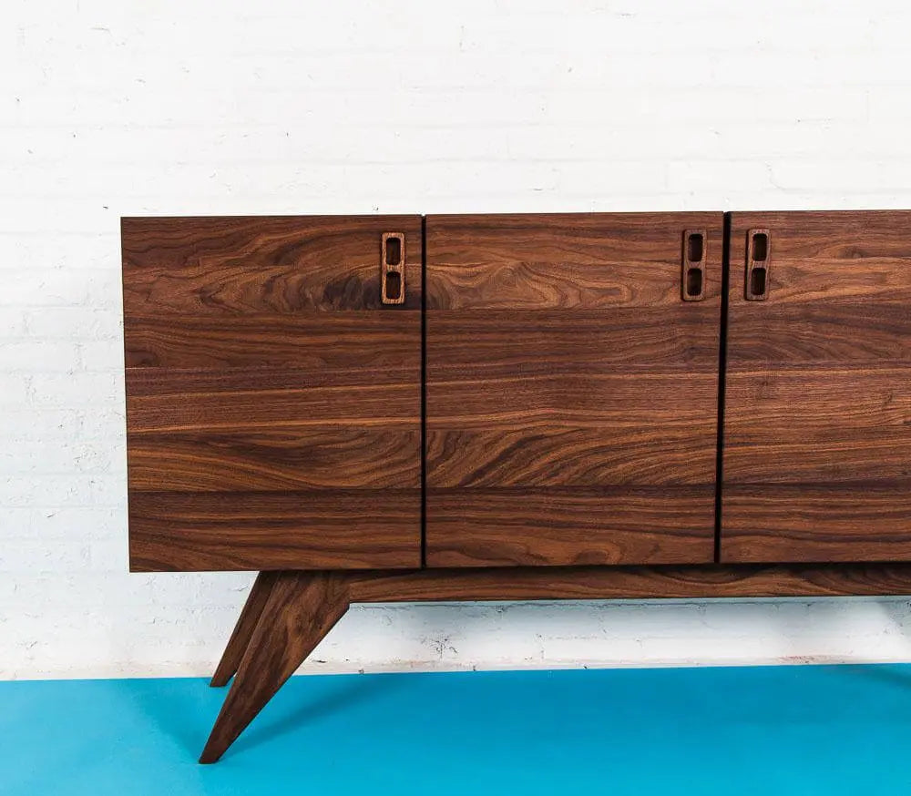 Walnut Mid Century Credenza, detail shot of walnut doors. Tapered Walnut Legs on Blue floor. 