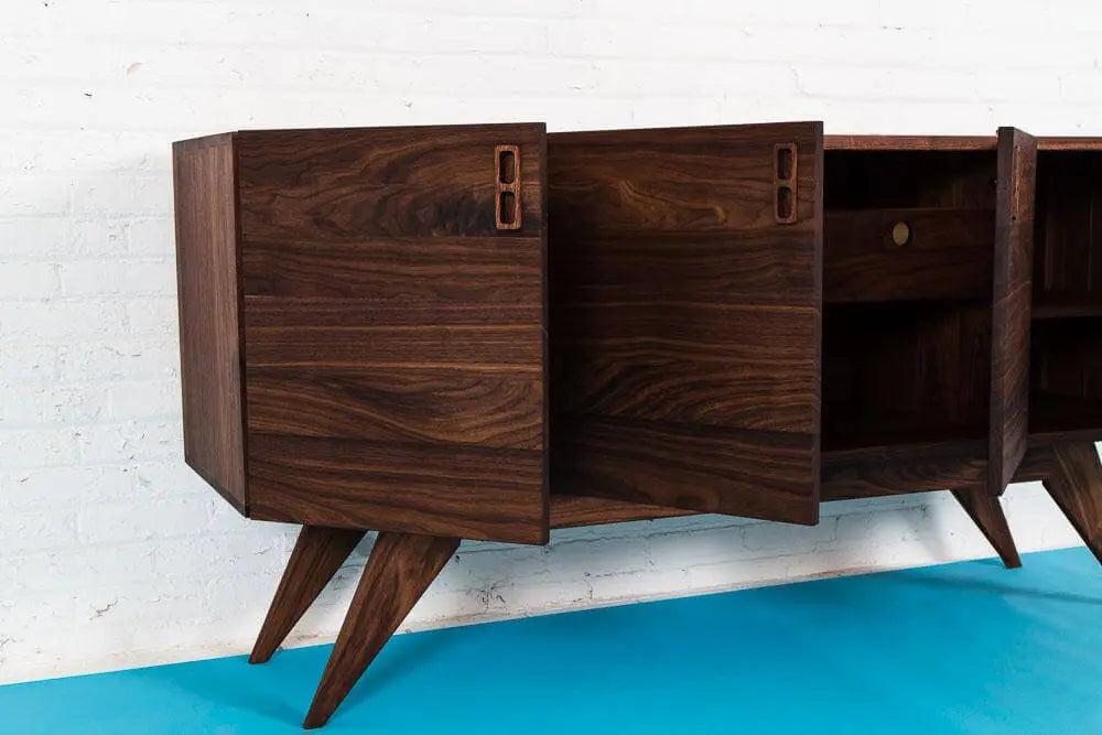 Mid-Century Modern four-door Credenza known as "The Haven" built with 1-inch thick solid walnut wood. Integrated wooden handles.