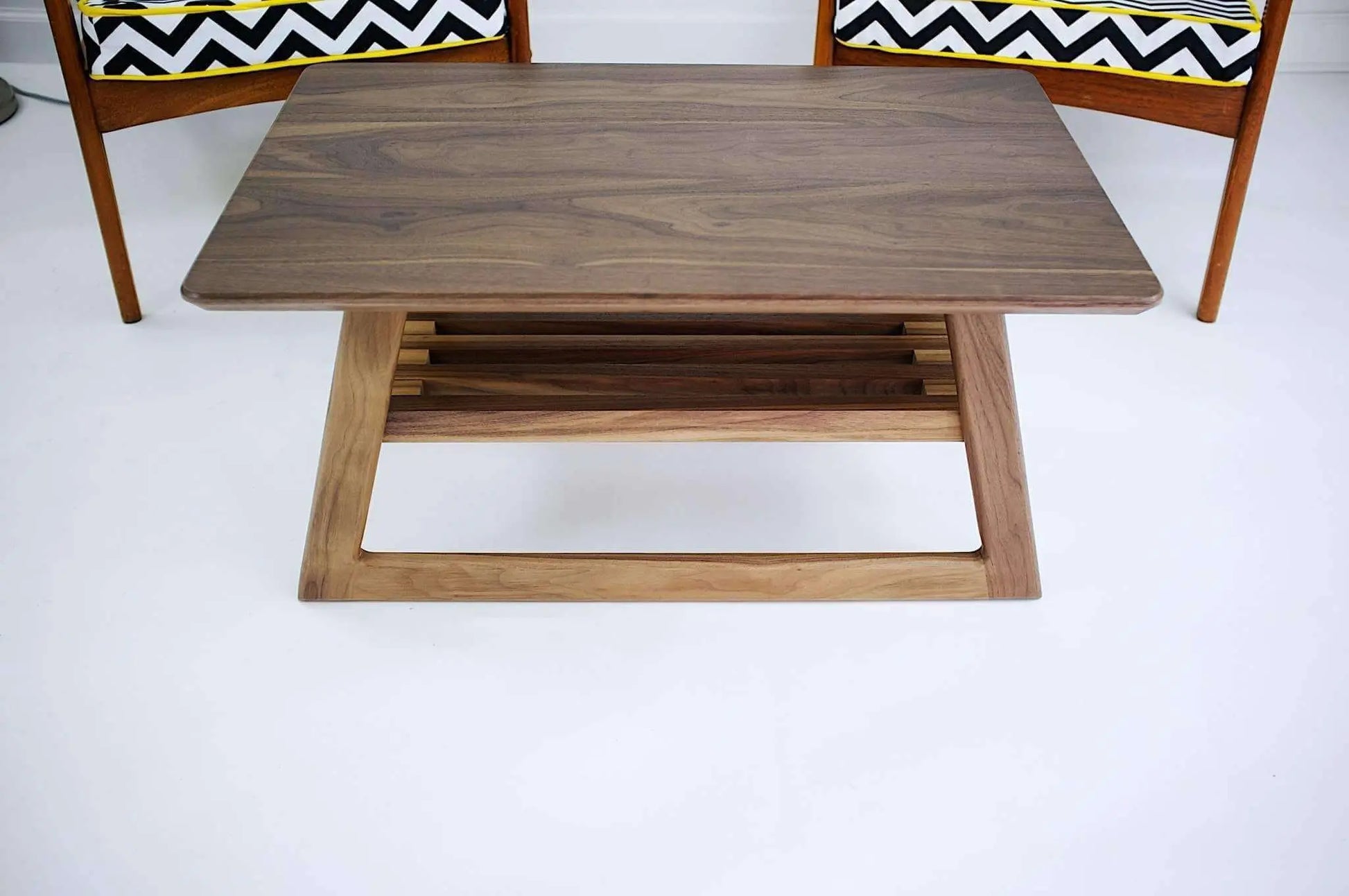 Angled view of "The Clevelander," showcasing its asymmetrical legs, a fine example of the best in mid-century modern living room furniture.