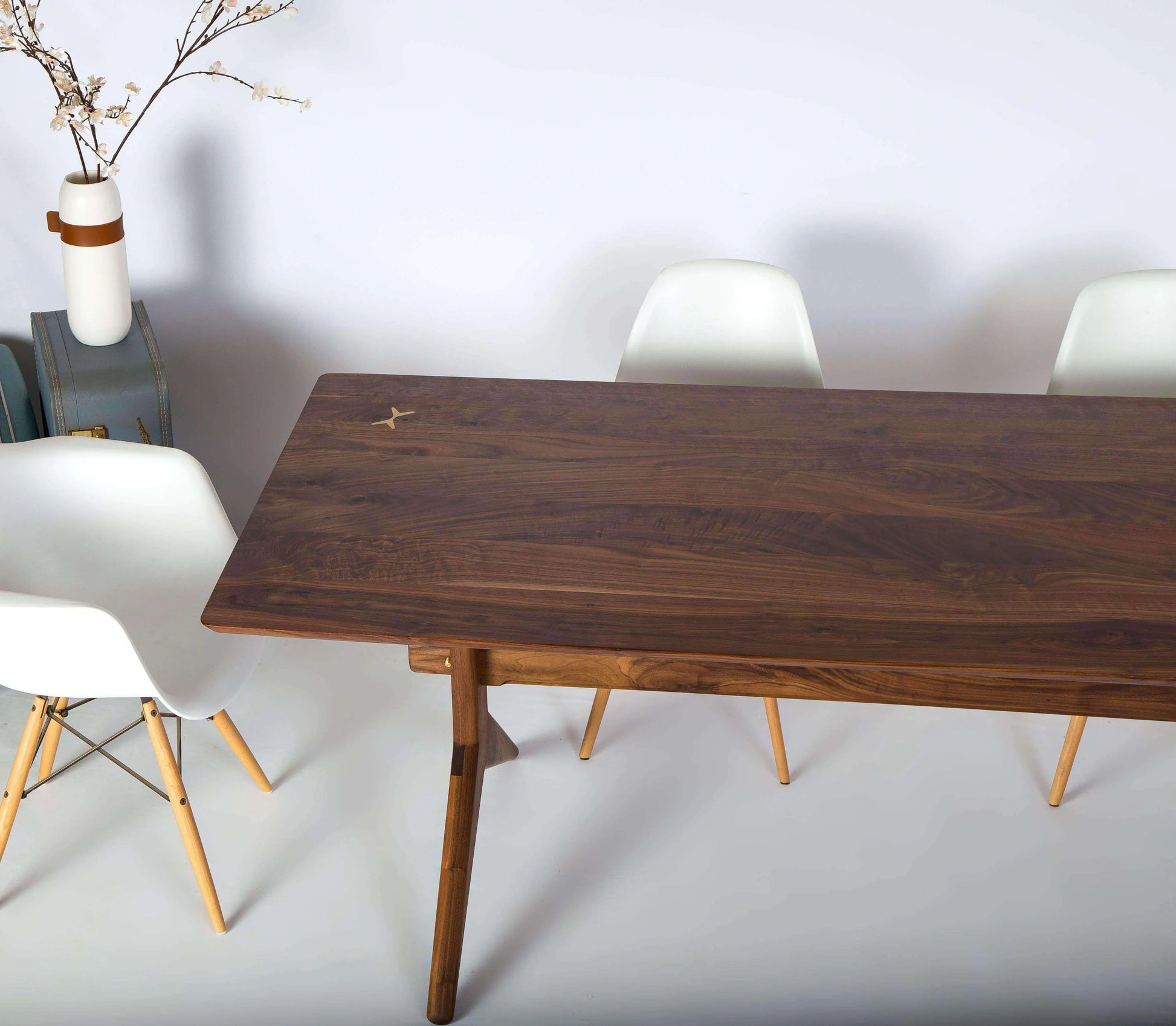 Mid-century inspired walnut dining table with a durable finish