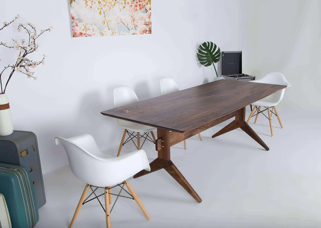 The Lanikai walnut dining table with a smooth, rich wood finish