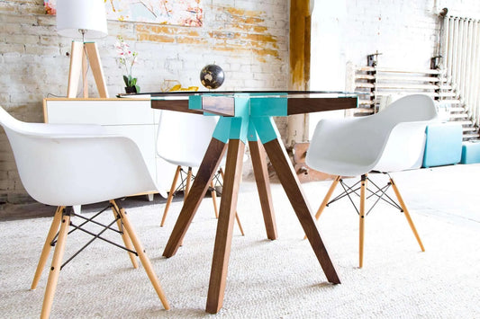 Sleek mid-century glass dining table with tapered wooden legs