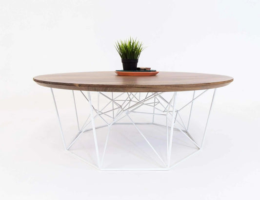 The Mila round coffee table with smooth walnut finish and tapered legs