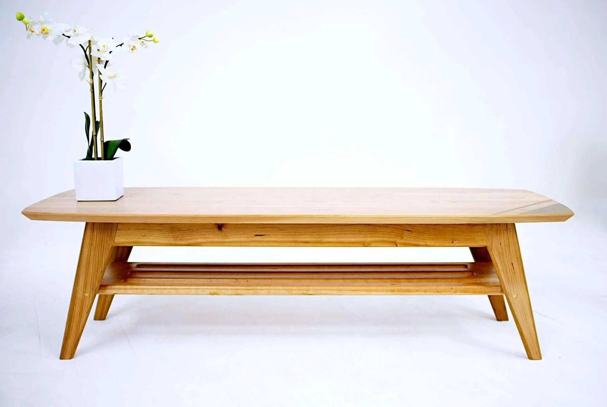 Natural wood coffee table with smooth finish and angled legs