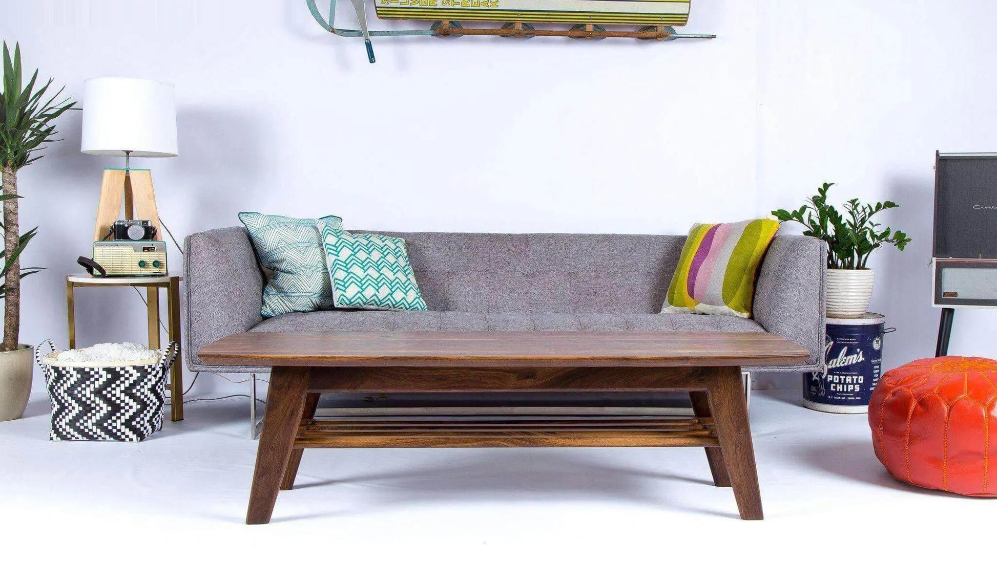 Sleek surfboard-shaped coffee table with tapered wooden legs