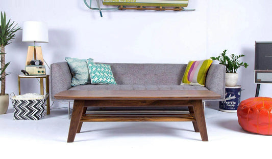 Sleek surfboard-shaped coffee table with tapered wooden legs