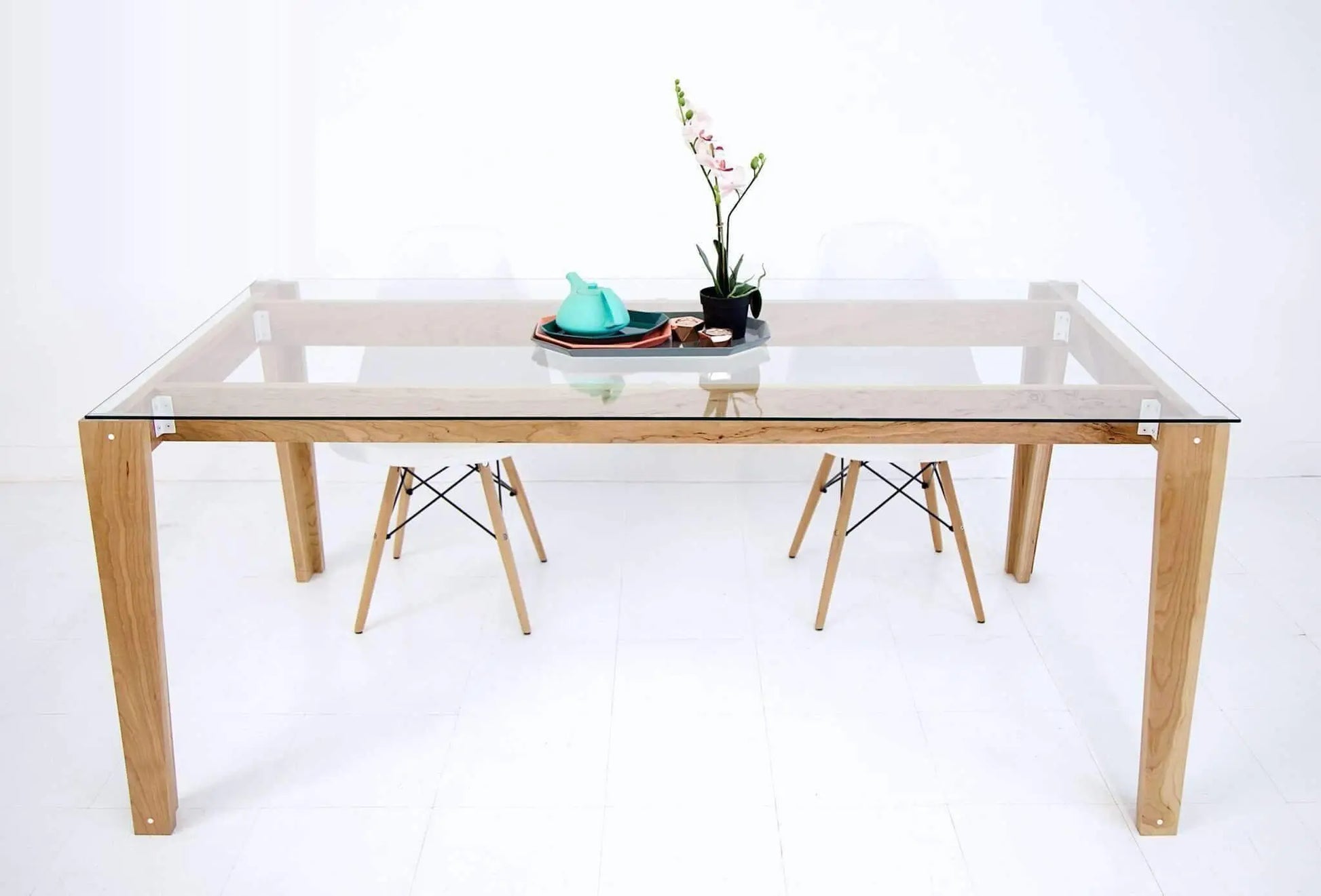 Classic mid-century glass dining table with a warm wood finish