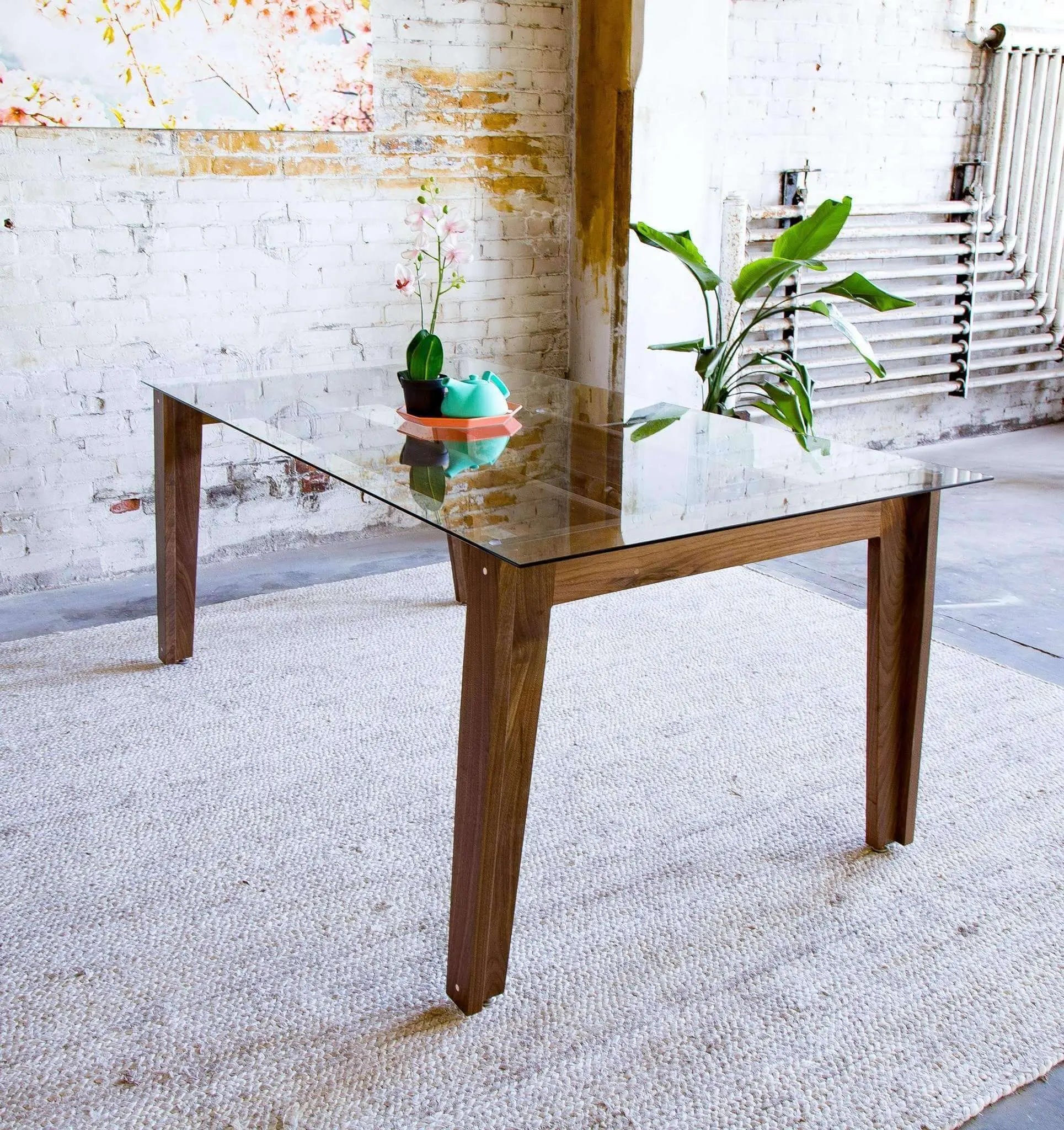 Timeless glass dining table with warm wood tones and tapered legs