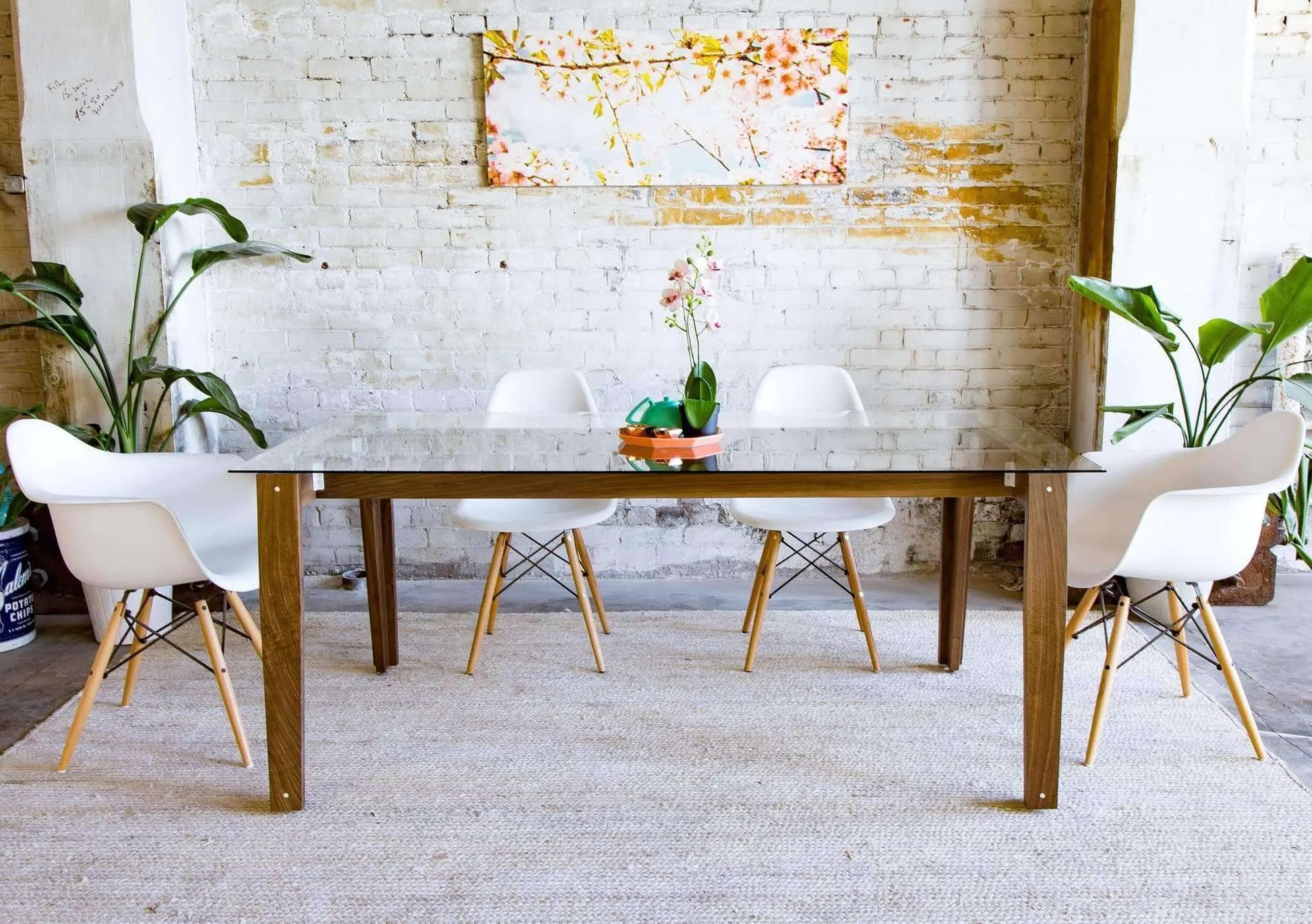 Mid-century dining table with tempered glass tabletop and wooden legs