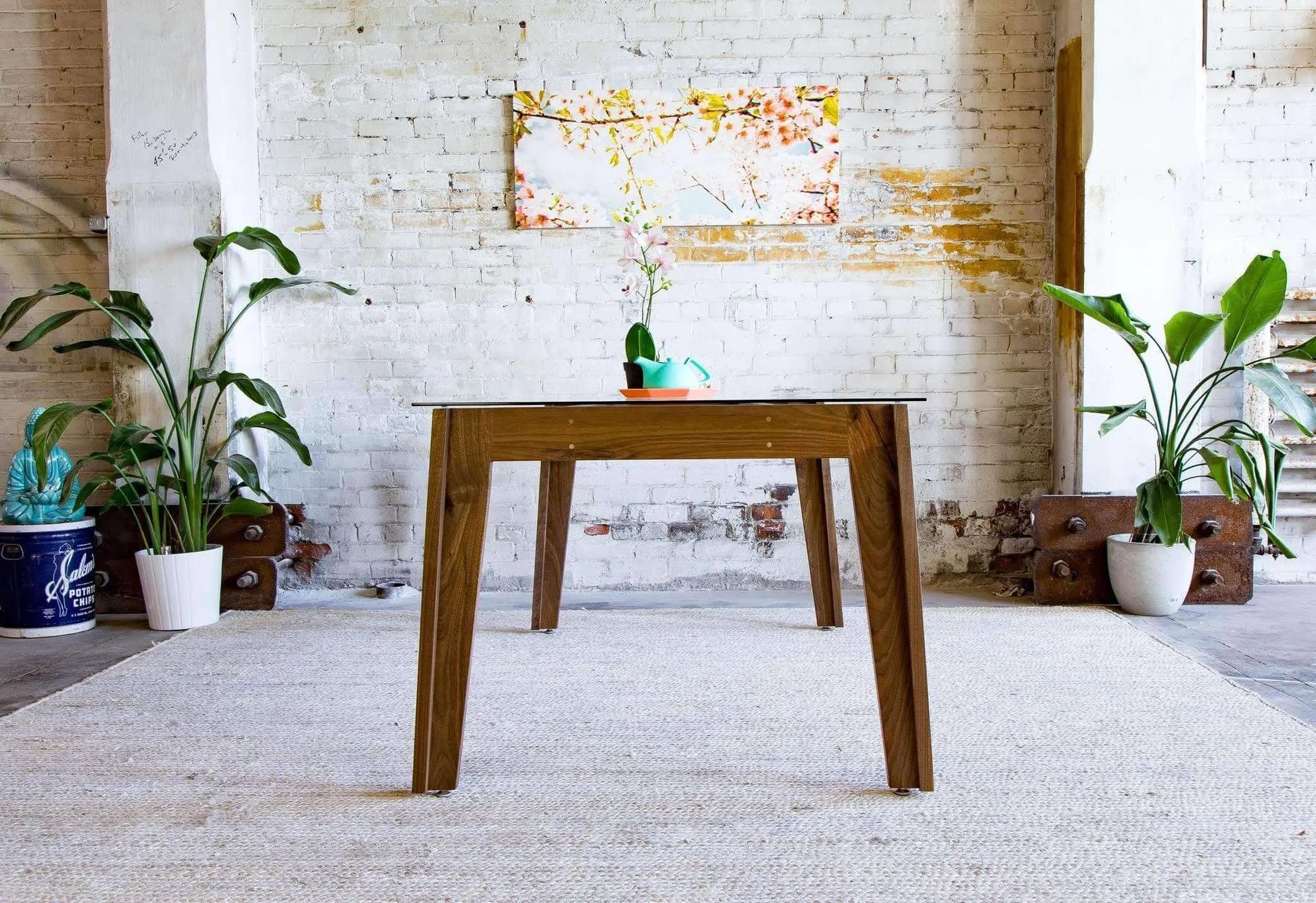 Minimalist mid-century dining table with durable tempered glass top