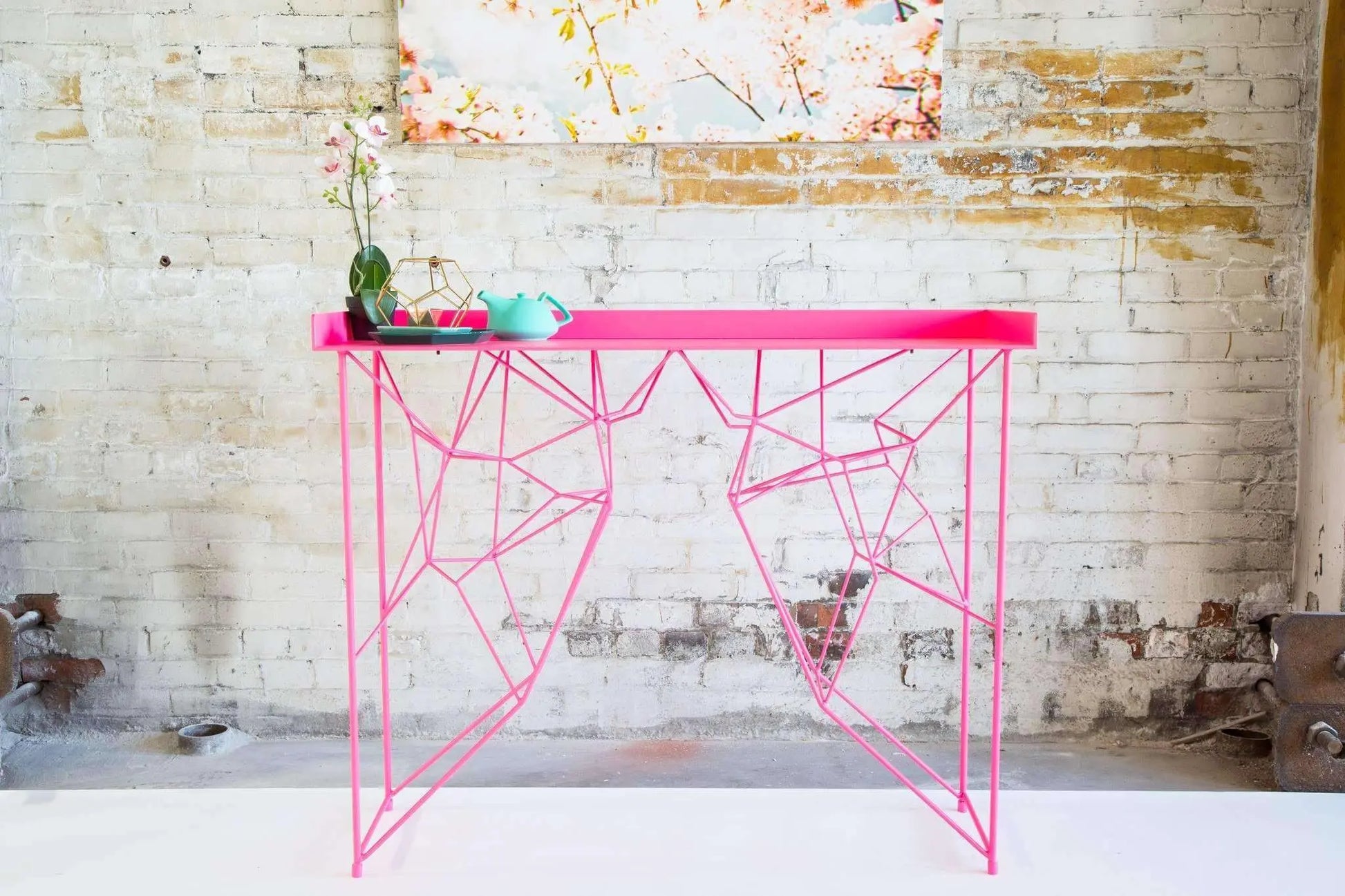 Minimalist pink console table with tapered legs and vintage charm